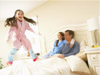 Girl jumping on bed